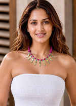 Handcrafted Banjara necklace with magenta glass barrels and gold spacers on a knotted thread cord
