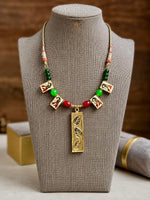 Meenakari enamel peacock charms in red, green and gold on a multicoloured braided cord with glass beads
